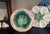 Majolica wall plate with pink basketweave background and a green maple leaf in the center. It was made by Griffin, Smith &...