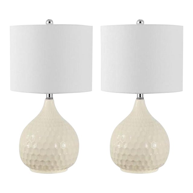 Give your décor an artistic modern touch with this Nalon Table Lamp. A textured hexagon honeycomb pattern swirls over...