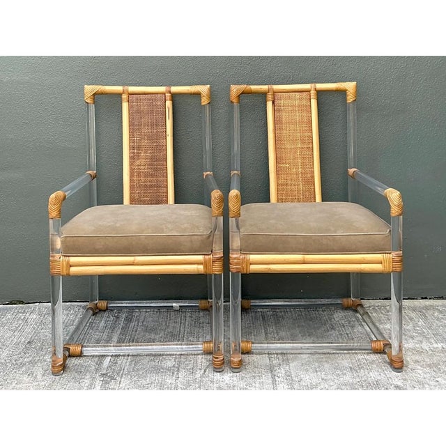 This pair of vintage armchairs joins thick, water-clear Lucite with warm natural rattan in an airy, architectural frame....
