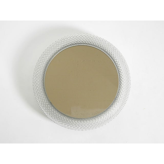 An original 1960s stunningly beautiful illuminated limburg crystal glass wall mirror. very high-quality craftsmanship in...