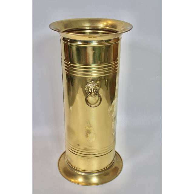 A stunning vintage brass umbrella stand with charming lion’s head handles, made in England, circa 1960s. This is a superb...