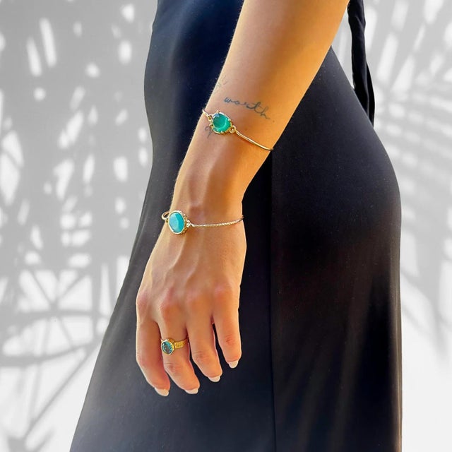 Embrace the timeless elegance of the Cleopatra Blue Topaz Adjustable Gold Ring. Whether worn as a standalone piece or...