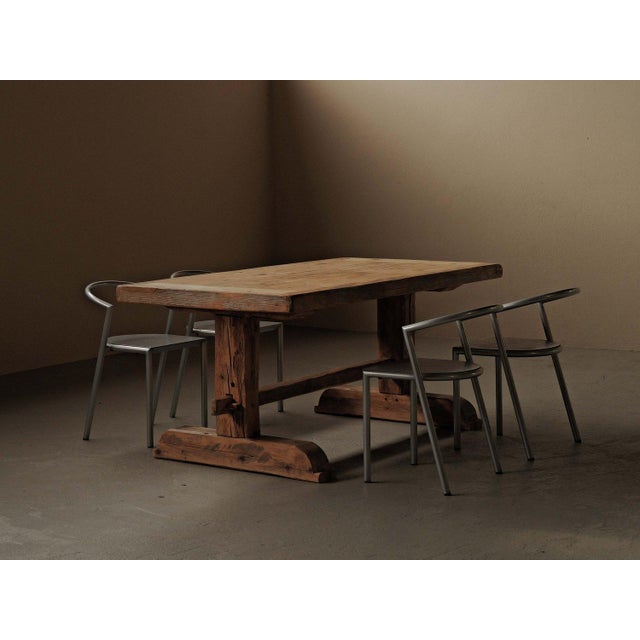 A “brutalist-inspired” dining table crafted from solid pine, dating to around 1970. The rectangular top, made from wide...