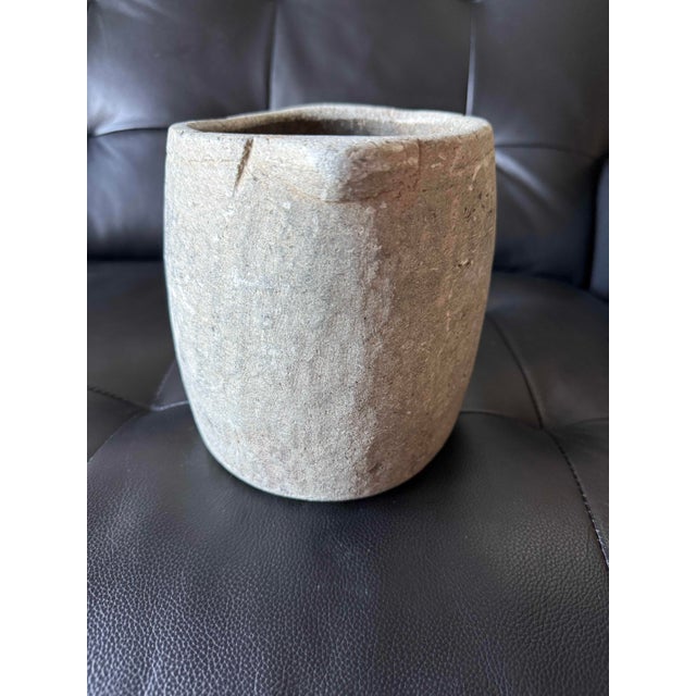 Beautiful hand-carved stone vessel with a substantial, primitive silhouette and naturally weathered surface. The exterior...