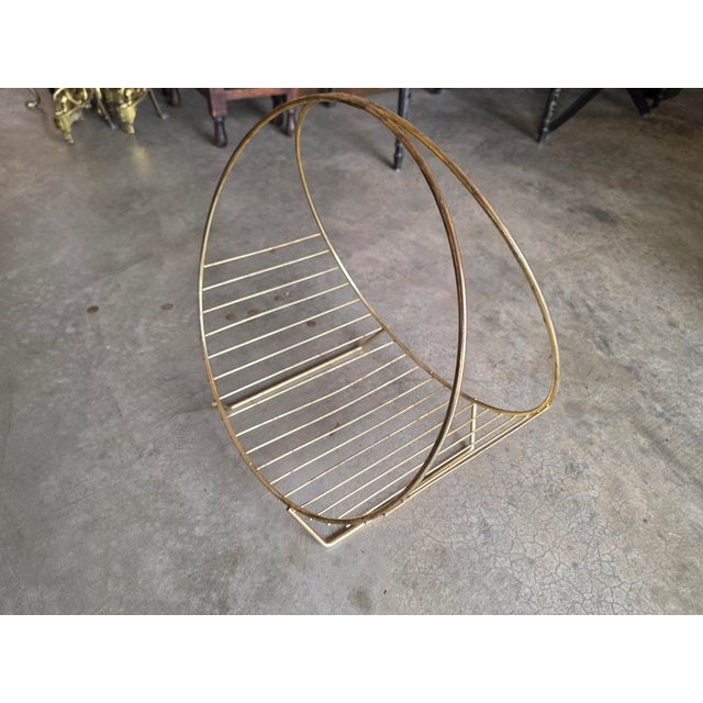 Bring classic atomic-era charm to your space with this vintage mid-century modern circular brass hoop rack. Featuring a...