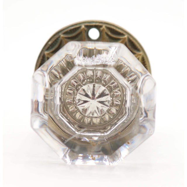 Antique octagon clear glass door knob paired with a spider web design brass rosette. The original rosette mounting screws...