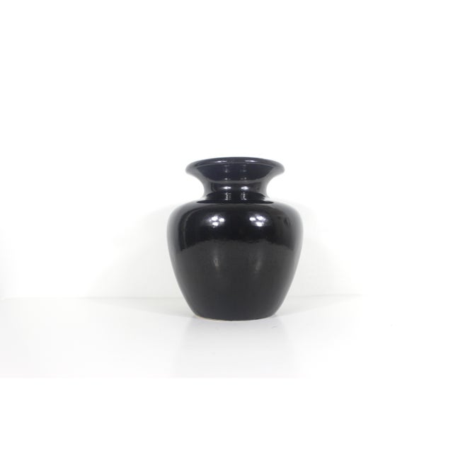 This is a great looking simple black ceramic vase made in West Germany in the 60’s. It is mid century modern style and...
