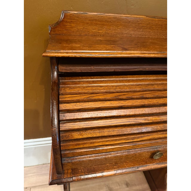 Bring timeless warmth to a child's room or cozy nook with this antique child’s roll top desk. Crafted from beautifully...