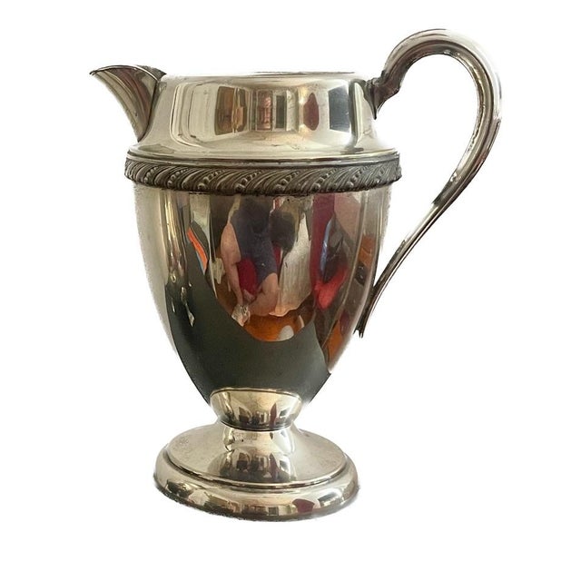 This stately mid-century water pitcher is beautiful example of the Regency Revival style which was rather popular in the...