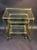 Quality pair of brass bamboo nesting tables designed by Baques fitted with two types of caster wheels. The smaller table...