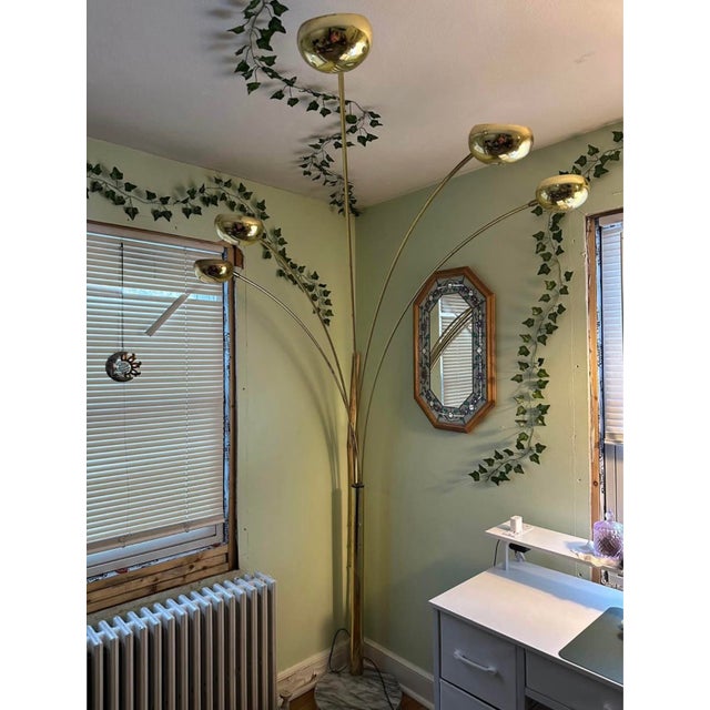 The Guzzini Arc Lamp from the 1980s exudes mid-century modern style with its brass construction and marble base. This...