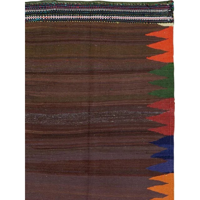 A vintage Persian flat-woven Kilim rug from the mid-20th century. A Kilim is a flat tapestry-woven carpet or rug...