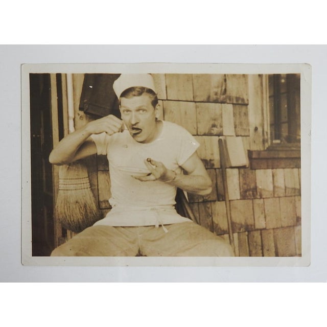 Early 20th century sepia tone snapshot photograph of a cook eating on break. Unframed, small corner crease.