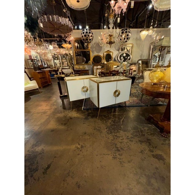 The product is a pair of elegant side tables made of Murano white glass and brass. These tables feature a sleek and modern...