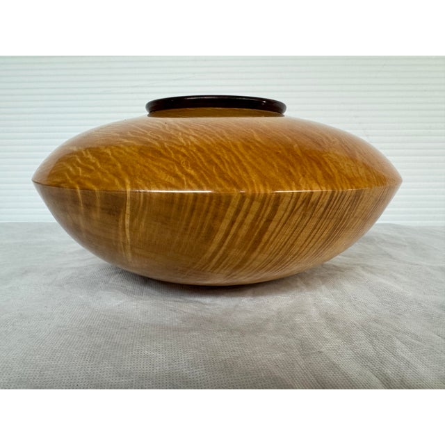 Design Plus Gallery presents a Shaped Vessel by Todd Lewis. The bowl is smooth as silk and made with two types of wood;...