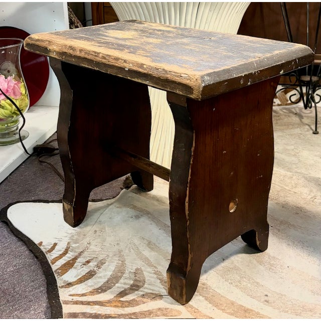 An old wood bench or stool made by hand in the early part of the 20th century. American. The wood surface has seen a lot...
