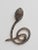 A pair of coiled snake earrings with round, brilliant cut diamonds set in rhodium plating with faceted ruby eyes. 18K gold...