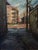 Golden Triangle Sunset by Jim Beckner | Oil on panel Alleyway scene with buildings at sunset. For Sale