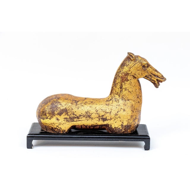 A vintage Chinese Han style gilded wooden horse sculpture of the head, mane, and muscular body in gold leaf with aged...