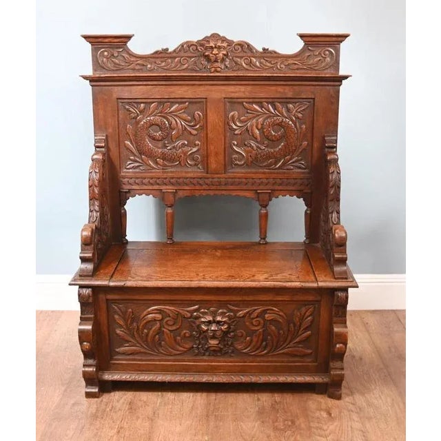 Finely carved oak hall bench or settle circa 1890 The bench opens to form a generous storage space. Various design...