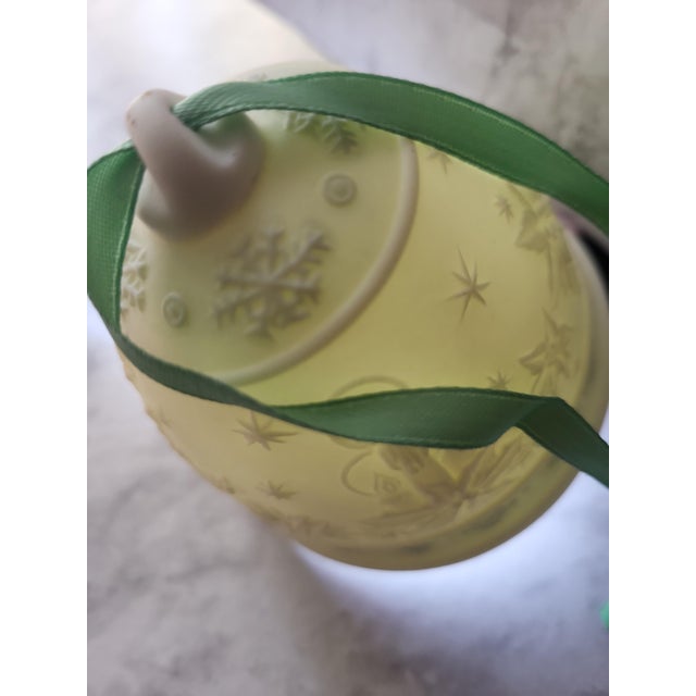 A beautiful vintage Lladro Christmas bell ornament. The delicate porcelain allows light through, as seen in photo....
