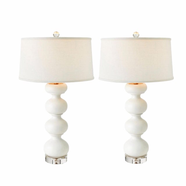 A sculptural pair of Global Views Stacked Bulb Table Lamps in a refined matte white finish. Designed with a rhythmic,...