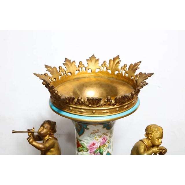 A Palatial French Ormolu-Mounted Sevres Porcelain Hand-Painted Vase and Cover, circa 1838. This monumental Sevres...