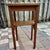 Solid wood plant stand or small side table with a simple, functional Arts & Crafts–style design. The piece features a...