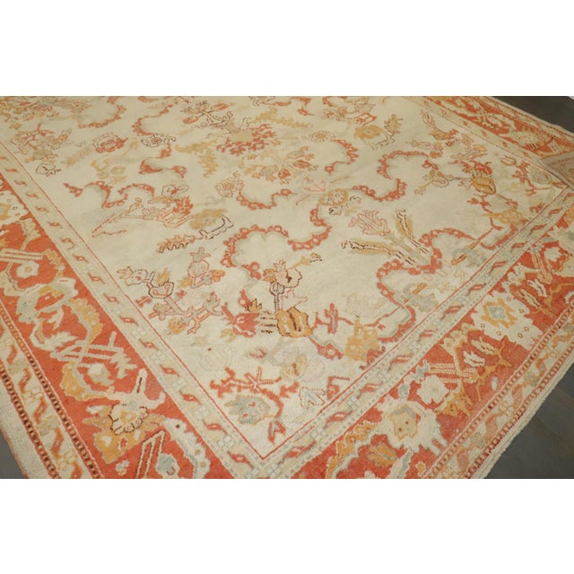 A late 19th century Turkish Oushak in predominant ivories and orange. Measures: 10'7" x 13'3" Oushak carpets are Turkish...
