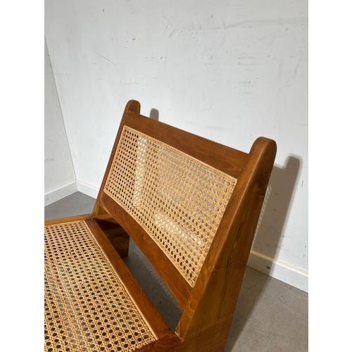 Beautiful vintage low lounge chair featuring a striking architectural design with solid wood construction and handwoven...