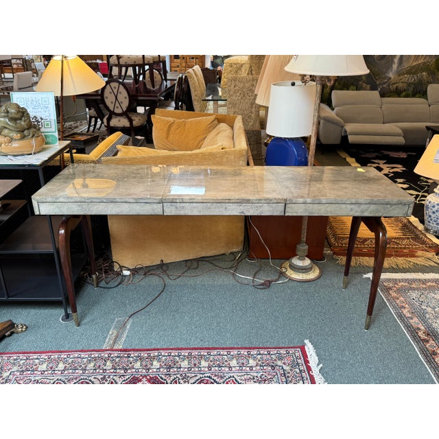 Design Plus Gallery presents a One-of-a-Kind Writing Desk. The desk offers a duo of prong shaped legs in a dark...