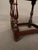 An authentic 18th-century English country oak low stool, circa 1780, featuring hand-turned legs and traditional mortise-...