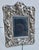 Sterling silver photo frame with Putti designs. Frolicking around the borders, the theme of love and romance is on...