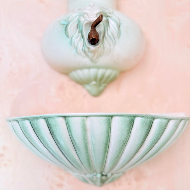 A rare and striking find — this vintage Royal Haeger wall-mounted lavabo features a boldly sculptural lion head motif with...