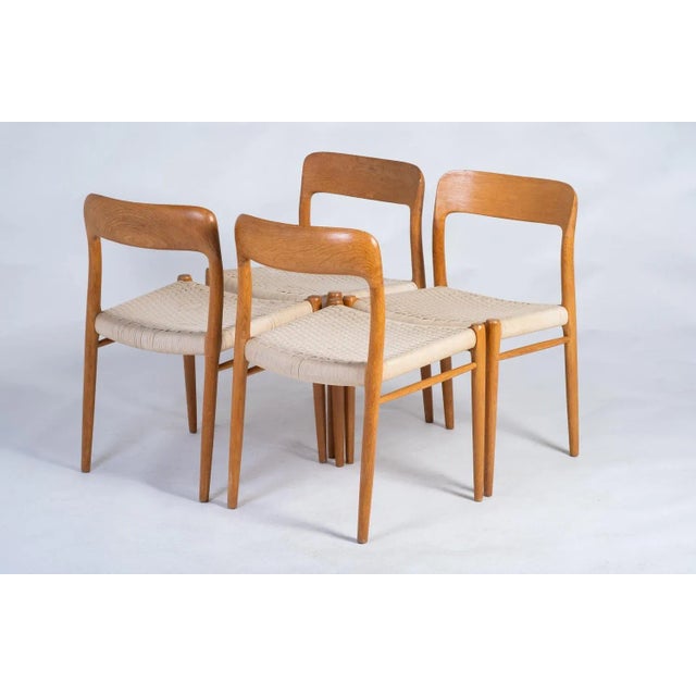 Set of four solid oak chairs by Niels Otto Møller, Model 75. Originally designed in 1956, this Model 75 chair by Niels...