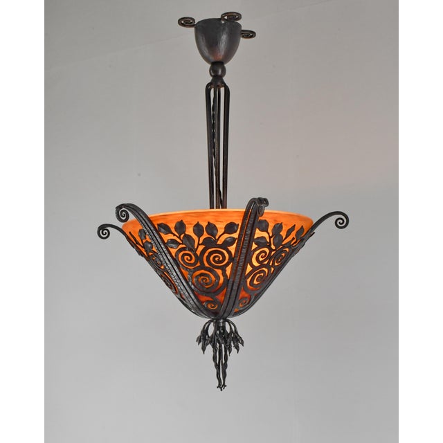 E. Brandt & Daum A beautiful French 1925-1930 art deco chandelier in wrought iron by edgar Brandt. It holds a glass bowl...