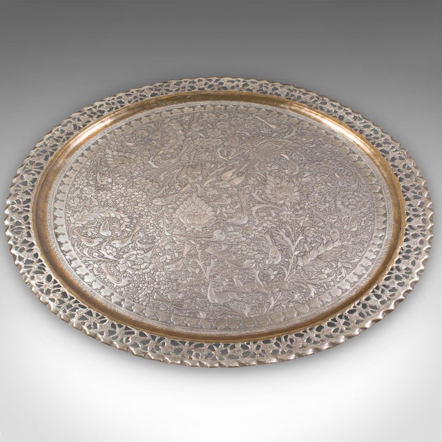 This is a large antique Kashmiri serving tray. An Indian, silvered brass decorative platter, dating to the late Victorian...