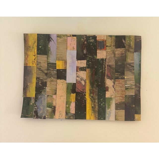 A striking contemporary diptych composed of layered paper fragments arranged in rhythmic vertical and horizontal bands....