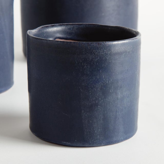 With a crackled glaze, uneven texture and basic form, this set of terracotta studio cachepots is simple and raw. In an...