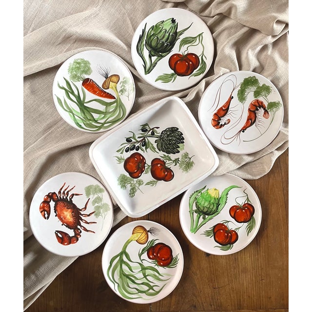 A glazed terracotta dinner service made by the renowned Marius Bessone workshop in Vallauris. This set includes six round...