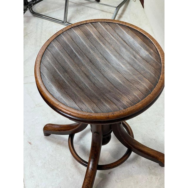 Exceptional Art Deco adjustable piano stool manufactured by Fischel in Czechoslovakia during the 1930s. Crafted from solid...