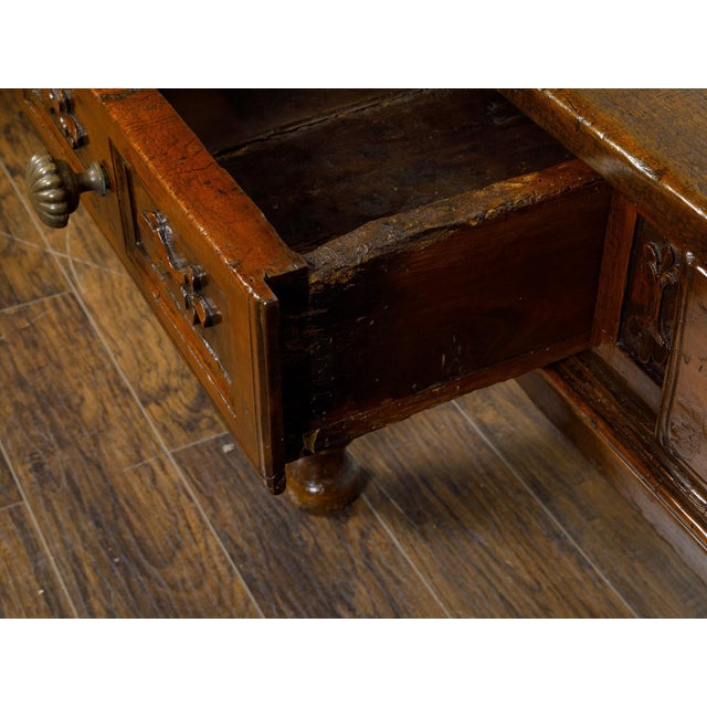 A Spanish walnut console table from the 18th century with two carved drawers, turned baluster legs and H-Form cross...