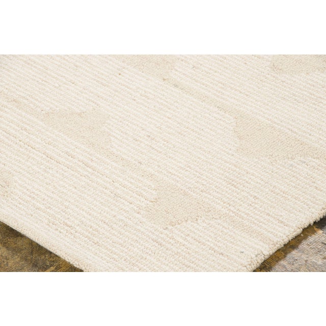 Hand-tufted in wool, this 4x6 contemporary geometric rug showcases an all-over lattice of repeating diamond motifs in warm...
