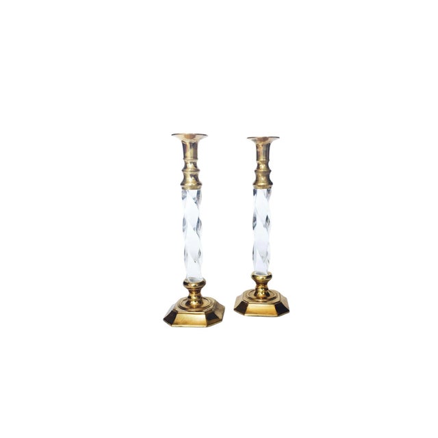 An elegant set of two lucite and brass vintage candlesticks. Each candlestick has a brass top and base with a lovely...