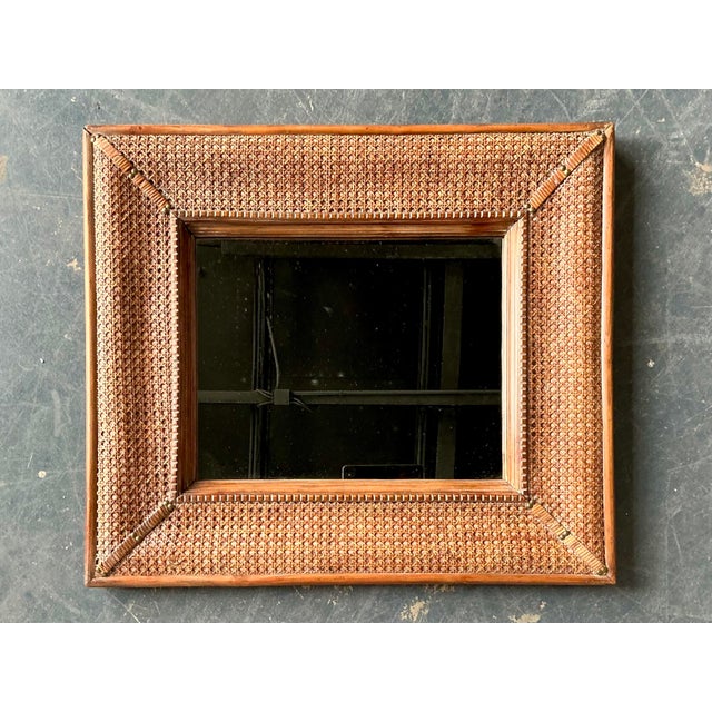 This exquisite vintage wall mirror is a masterclass in coastal sophistication, featuring a wide frame masterfully wrapped...