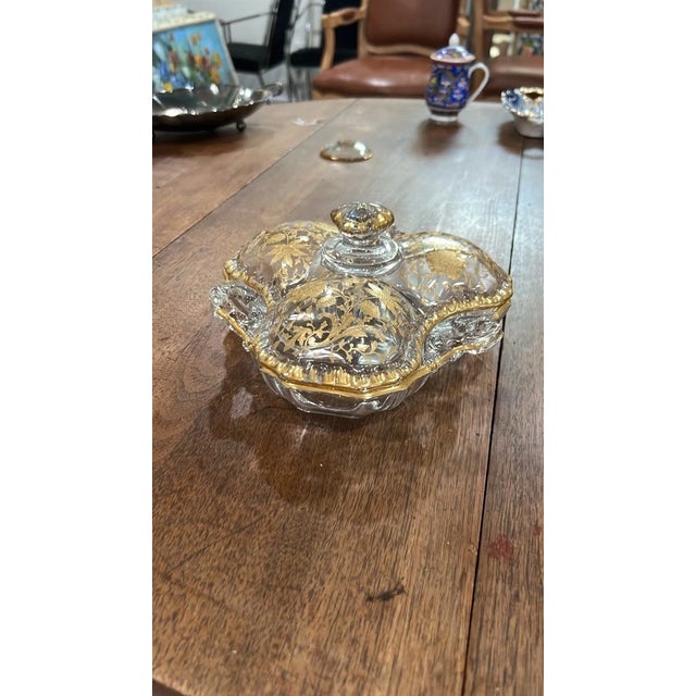 Add elegant vintage glamour to your entertaining setup or vanity with this ornate 3-section lidded glass dish. Crafted...