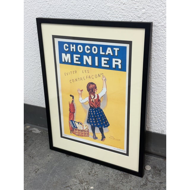 Design Plus Gallery presents a Framed Chocolat Menier Advertising Print after R.Bouisset’s Circa 1920 Poster. The 1996...