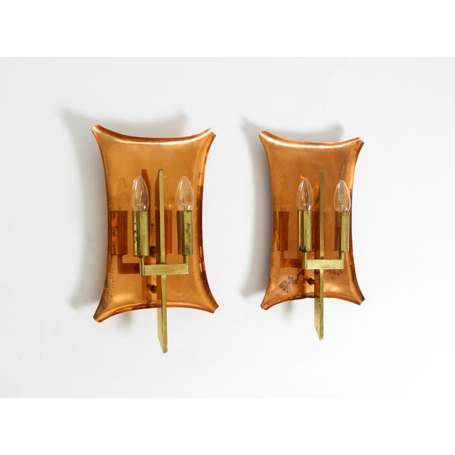 Two large, heavy wall lamps made of copper and brass. Great mid-century design. They hung in a church in Germany for...
