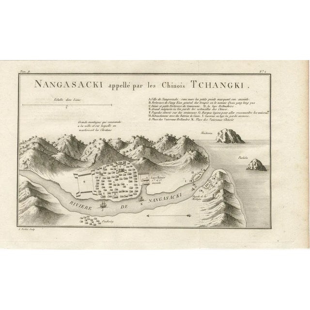 This finely engraved 18th-century map depicts the japanese port city of nagasaki (nangasacki), here noted as being called...