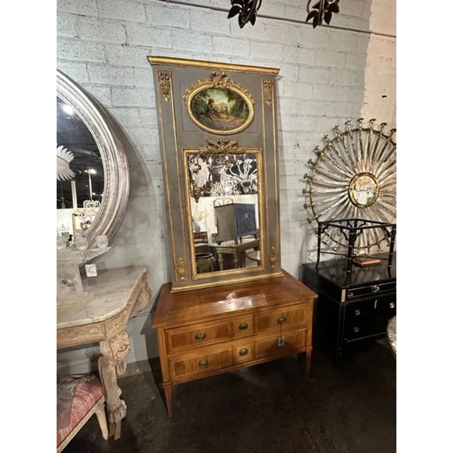 19th century French carved and parcel gilt trumeau mirror with oil on panel of boy and dog. Circa 1850. A fine addition to...